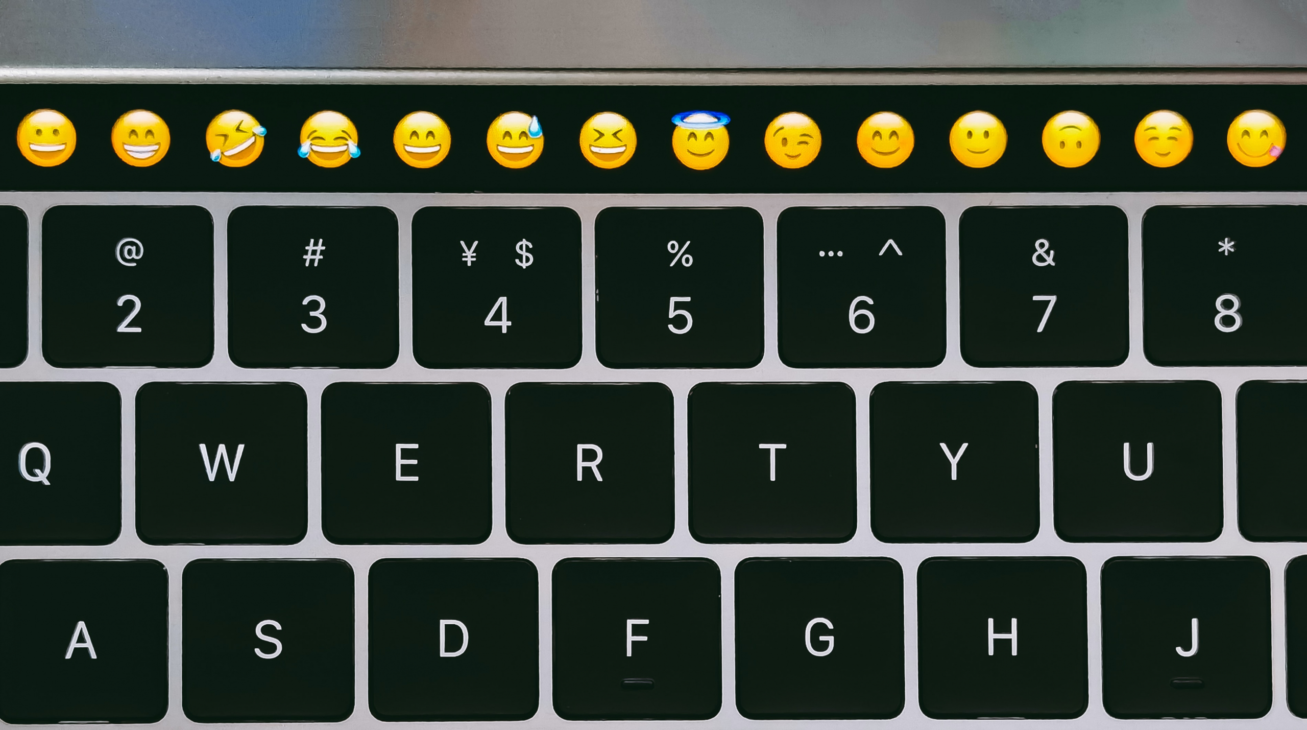 Emojis on top bar of laptop