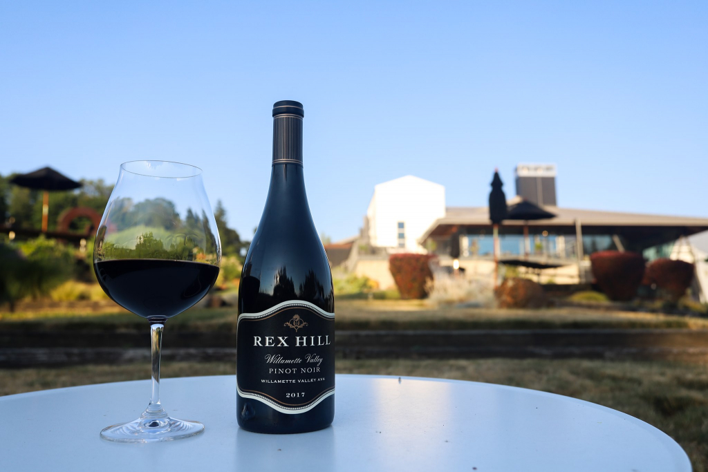 Rex Hill wine bottle and wine glass on table