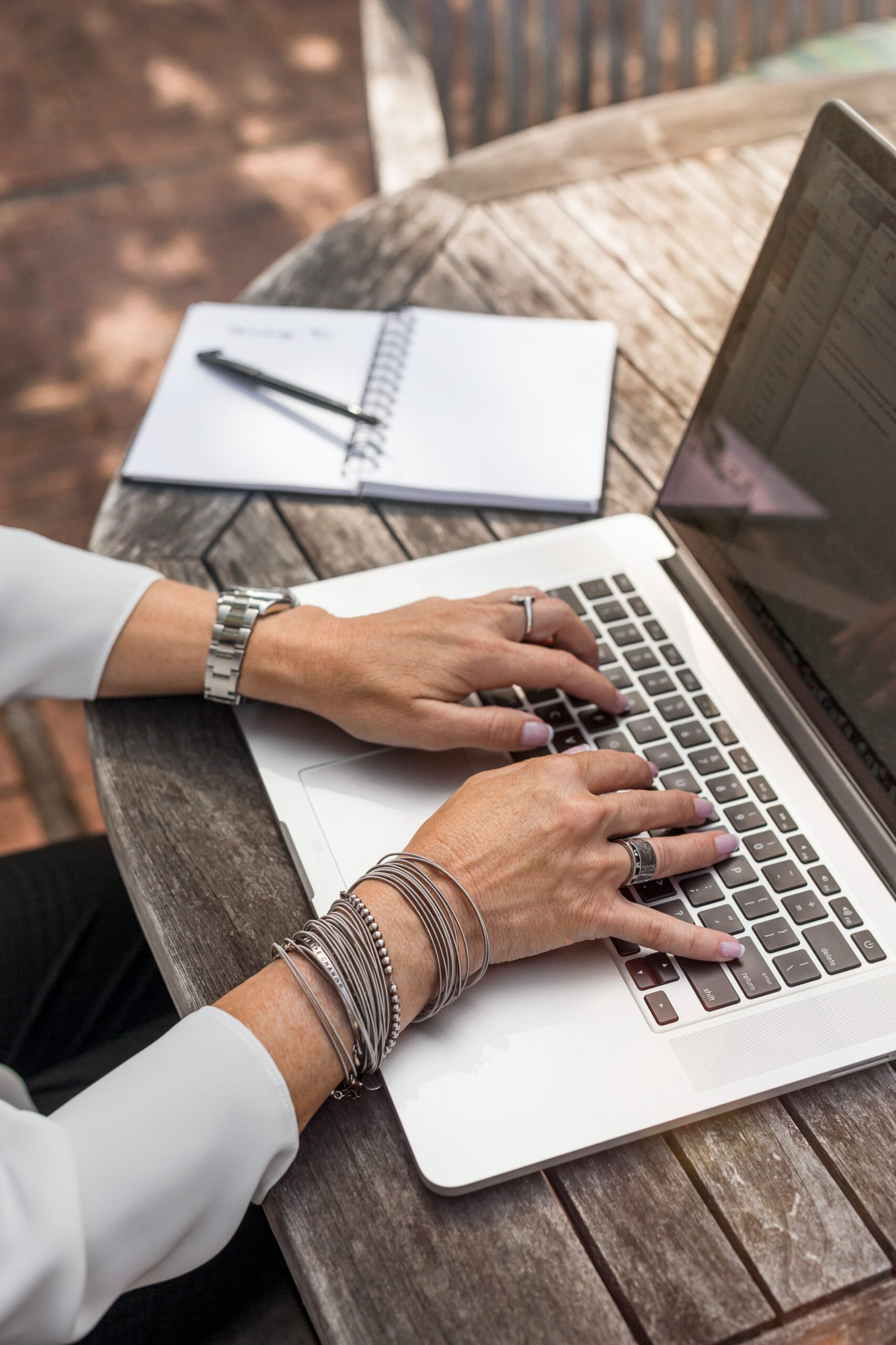 Image of person's hands typing on laptop keyboard